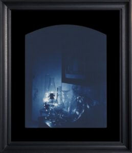 Framed artwork of illuminated glass objects.