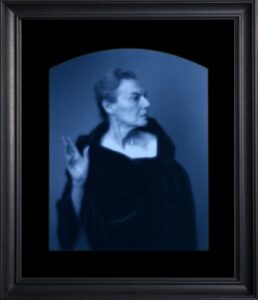 Portrait of a woman in dark clothing.