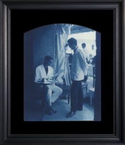 Two men in a vintage cafe setting.