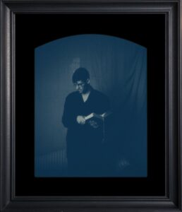 Person reading a book in dim light.