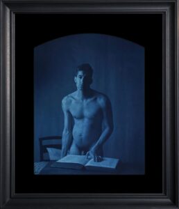 Nude male figure with book, blue tint.