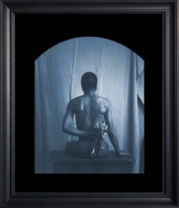 Framed art of person holding flowers.