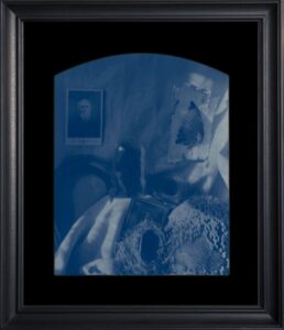 Blue monochrome abstract art in black frame.