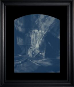 Glass with spoons in artistic monochrome photo.