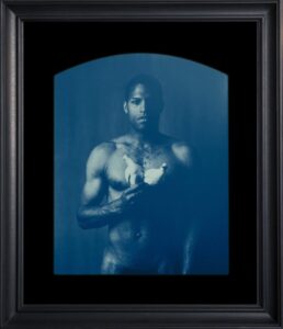 Man holding a white dove, blue tint.