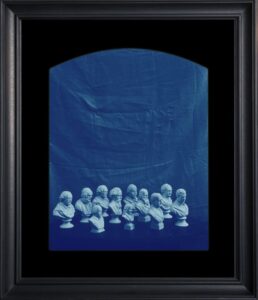 Framed blue image of classical busts.