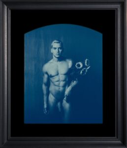 Framed blue-toned portrait of a person.