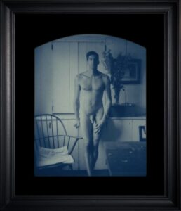 Framed artistic photograph of a nude male.
