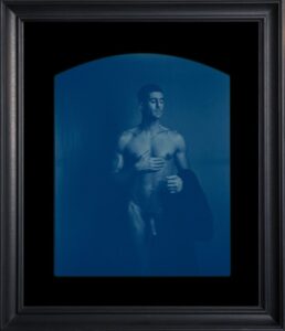 Framed blue-toned image of a posing man.