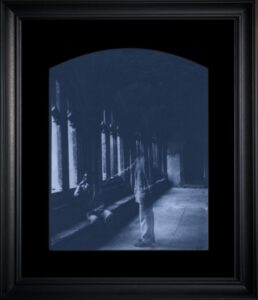 Ghostly figures in dark, arched hallway.