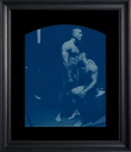 Two men posed in artistic cyanotype photograph.