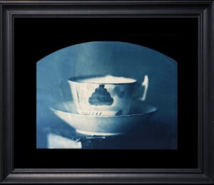 Framed blue-toned teacup and saucer artwork.