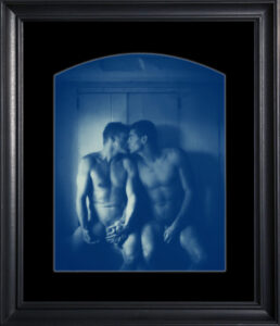 Two people sitting closely in blue tint.